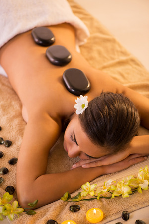 Young beautiful woman relaxing and enjoying at Lastone Therapy.の写真素材