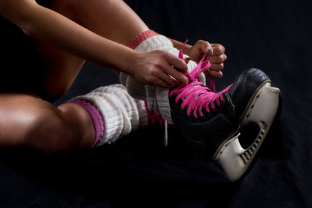 Woman Binding ice skate shoes