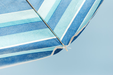 Blue beach umbrella and the sky in the backgroundの写真素材