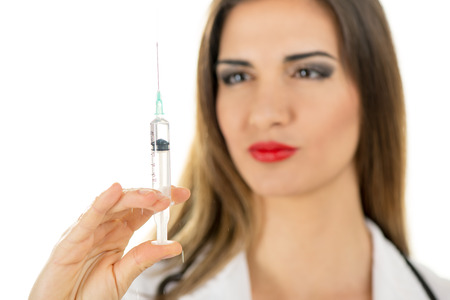 Close-up of a beautiful nurse holding injections. Focus on injections.の写真素材