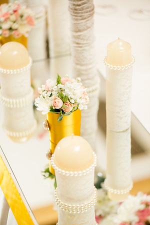 Wedding table decoration with candle, flowers and glasswareの写真素材