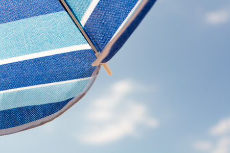 Blue beach umbrella and the sky in the backgroundの写真素材