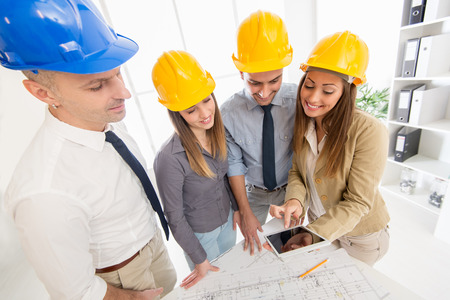 Successful architect team checking the projects on a tabletの写真素材