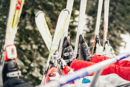 Four unrecognizable skier driving on ski lift. Close-up of a skis.の写真素材