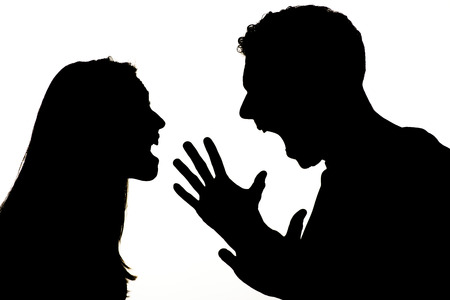 Silhouette of couple violence. They are angry and shouting face to face.の写真素材