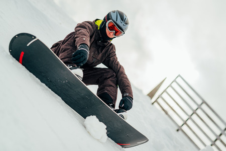 Young man with snowboard enjoying a winter day.