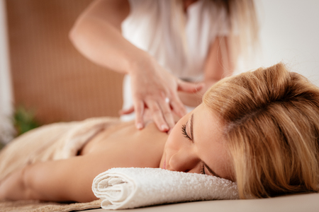 Woman enjoying during a relax massage at the spa. の写真素材