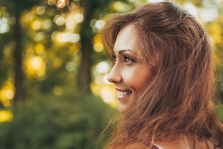 Portrait of a cute smiling girl in the nature.の写真素材