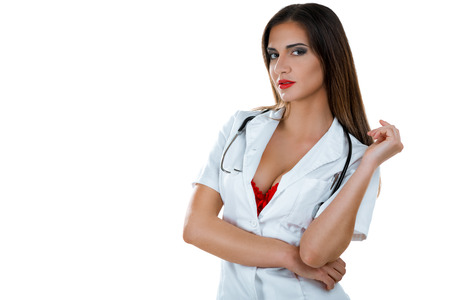 Beautiful sexy female doctor with stethoscope posing isolated on white background. Looking at camera.の写真素材