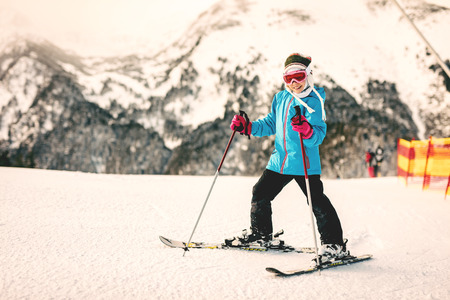 Little girl learns to skiing, on the mountain, and enjoying in nice snow day.の写真素材