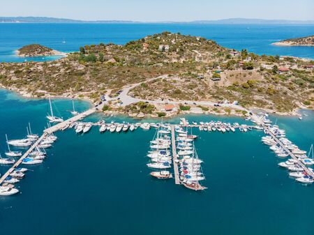Aerial view of marina with boats, sailboats and yachts on port of mediterranean little town. Top...