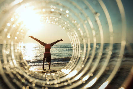A beautiful creative composition of a sea landscape shot through a circle focus showing a teenage...
