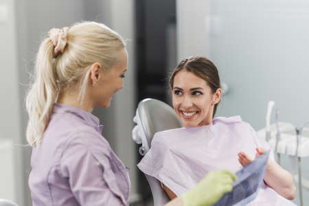 Shot of a young woman having a consultation with her dentist.の写真素材