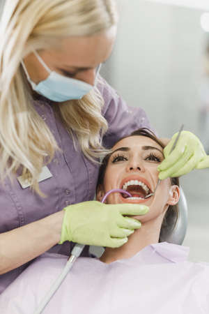 Shot of a young woman having dental work done on her teeth.の写真素材