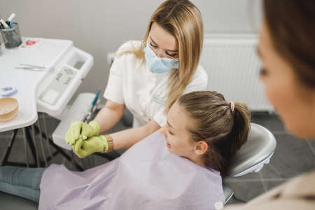 Shot of a teenager girl having a consultation with her dentist.の写真素材