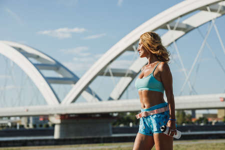 Adult running woman exercise outdoor. She is exhausted after hard training.の写真素材