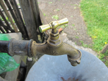 old rusty faucet in village yard for backgroundの写真素材