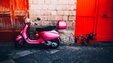 Pink girl italian moped with red helmet in summer Sorrentoの写真素材