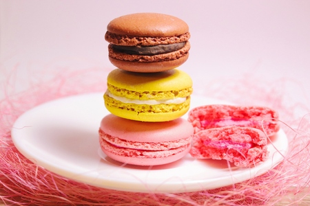 Macaroons stack of different colors standing on white plate. Front view.の写真素材