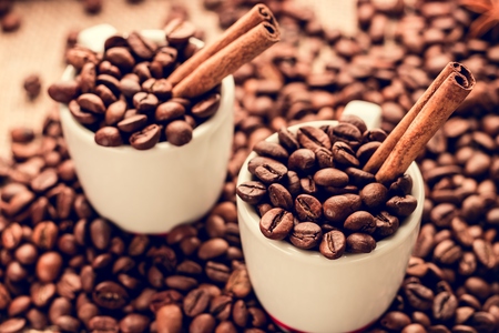 White espresso cups with coffee beans and cinnamon sticksの写真素材