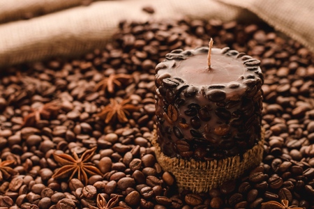 Brown candle with coffee beans backgroundの写真素材