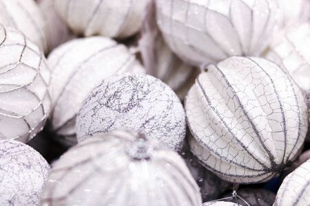 Christmas decoration white balls background of xmas tree toys with silver glitter. Post card for winter holidays wishes.の写真素材