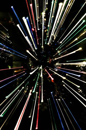Zoomed photo of Christmas tree colorful lights taken with long exposure and dynamic focus.の写真素材