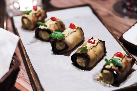 Georgian national fried eggplants rolls stuffed with ground walnuts and spices with pomegranate...