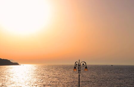 Sorrento peach color sky sunset twilight above the calm Tyrrhenian Sea. Peaceful Summer landscape. South Italy, Amalfi coast. Copy spaceの写真素材