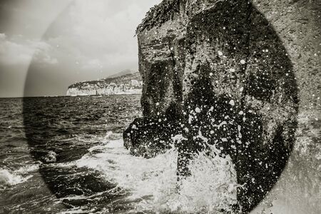 Wave splash on rock cliff in Sorrento, Marina grande, Italy, Amalfi coast, Campania. Black and white art photo seascape.の写真素材