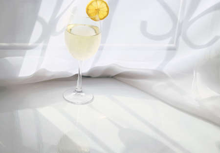 Limoncello or white wine in transparent long glassの写真素材
