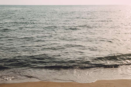 Beautiful water surface sea wave seascape soft focus background empty beach in cool blue and brown tones in Pontecagnano, Italy, Tyrrhenian sea.の写真素材