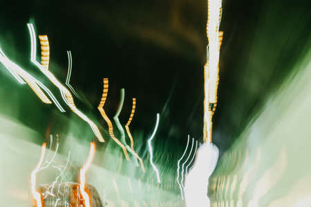 Driving in tunnel long exposure photo with colorful green and red defocused shaky lights. Italy....