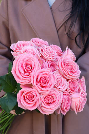 Spring flowers bouquets in pastel colors.. Couple man and woman hands holding white and pink tulips and hyacinths mono bouquets compliments on white wall background. Copy space, soft focus.の写真素材