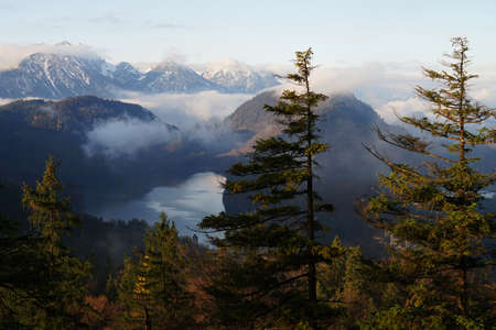 Early morning clouds above Alps and Alpsee lake, Bavaria, Germanyの写真素材
