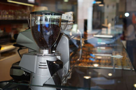 Professional coffee beans grinder and maker in  a cafeの写真素材