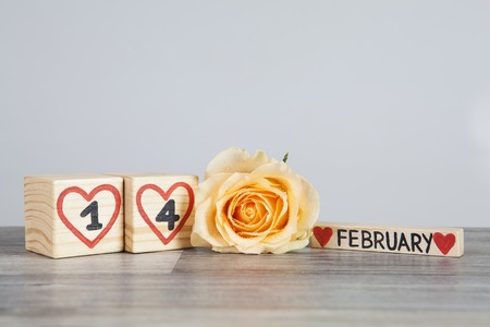 Wooden calendar and yellow rose.の写真素材