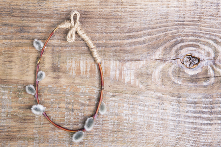 Egg shaped pussy willow branch. Easter composition on a wooden background. Copy space.の写真素材