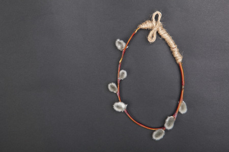 Egg shaped pussy willow branch. Easter composition on a black background. Copy space.の写真素材