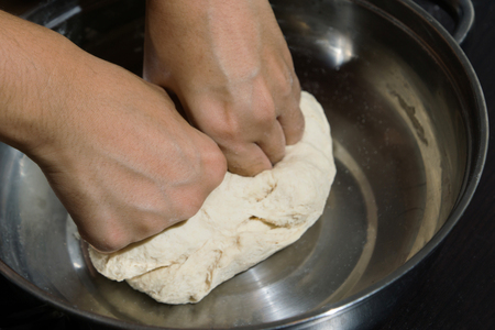 Close up woman hand  threshing flour in staninless blow preparation step to cooking some food that by flourの写真素材