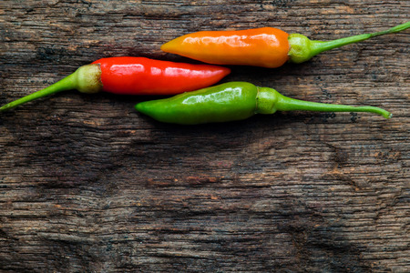 Top view colorful of chilli on dark wood 