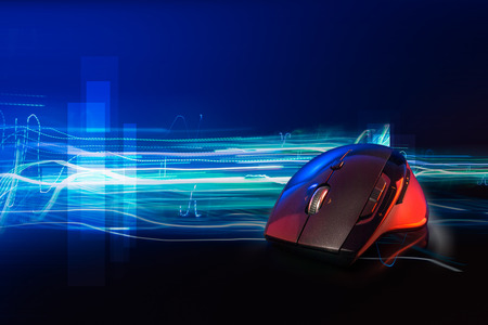 High technology computer gaming mouse fast moving  in blue tone with stroke of lightning as background の写真素材