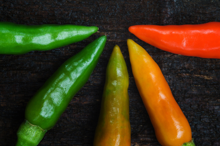 Top view colorful of chilli on dark wood の写真素材