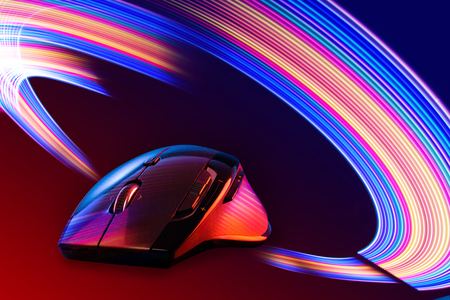 High technology computer gaming mouse in dark blue tone on the metal surfaceの写真素材
