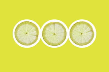 Flat lay Background Slice of lemon on a green backgroundの写真素材