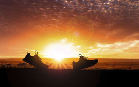 Concept design for Trail running : Silluette running Shoe runnong along the track at the sunset time.の写真素材