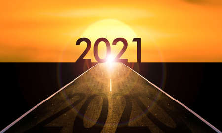 New year 2021 or start straight concept.word 2020 written on the asphalt road at sunset.の写真素材