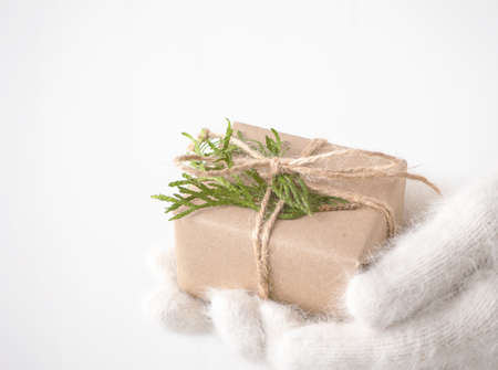 Hands in white gloves hold Christmas decorの写真素材