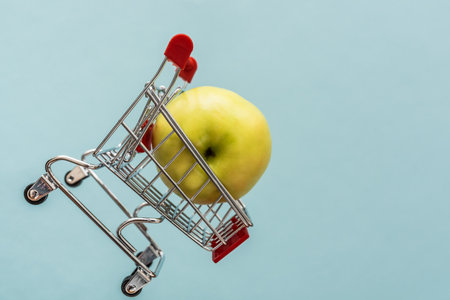 Flying cart. selling fruit in a supermarket. Shop sale concept. On a blue background.の写真素材
