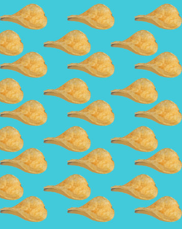 Background from potato chips. Isolate on a blue background. Junk food made from cholesterol. Salty and crispy. Fast food snack. Yellow color.の写真素材